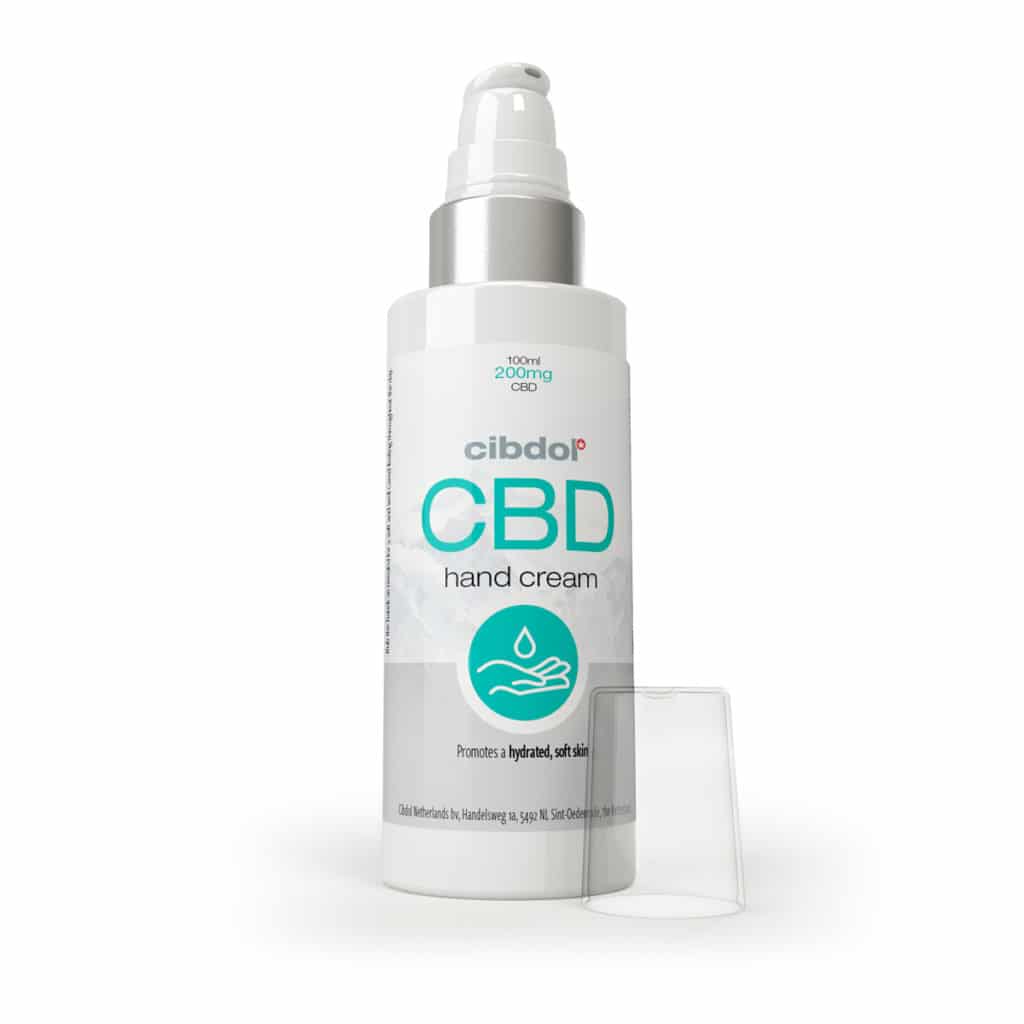 eine flasche cbd-handcreme neben einem behälter.